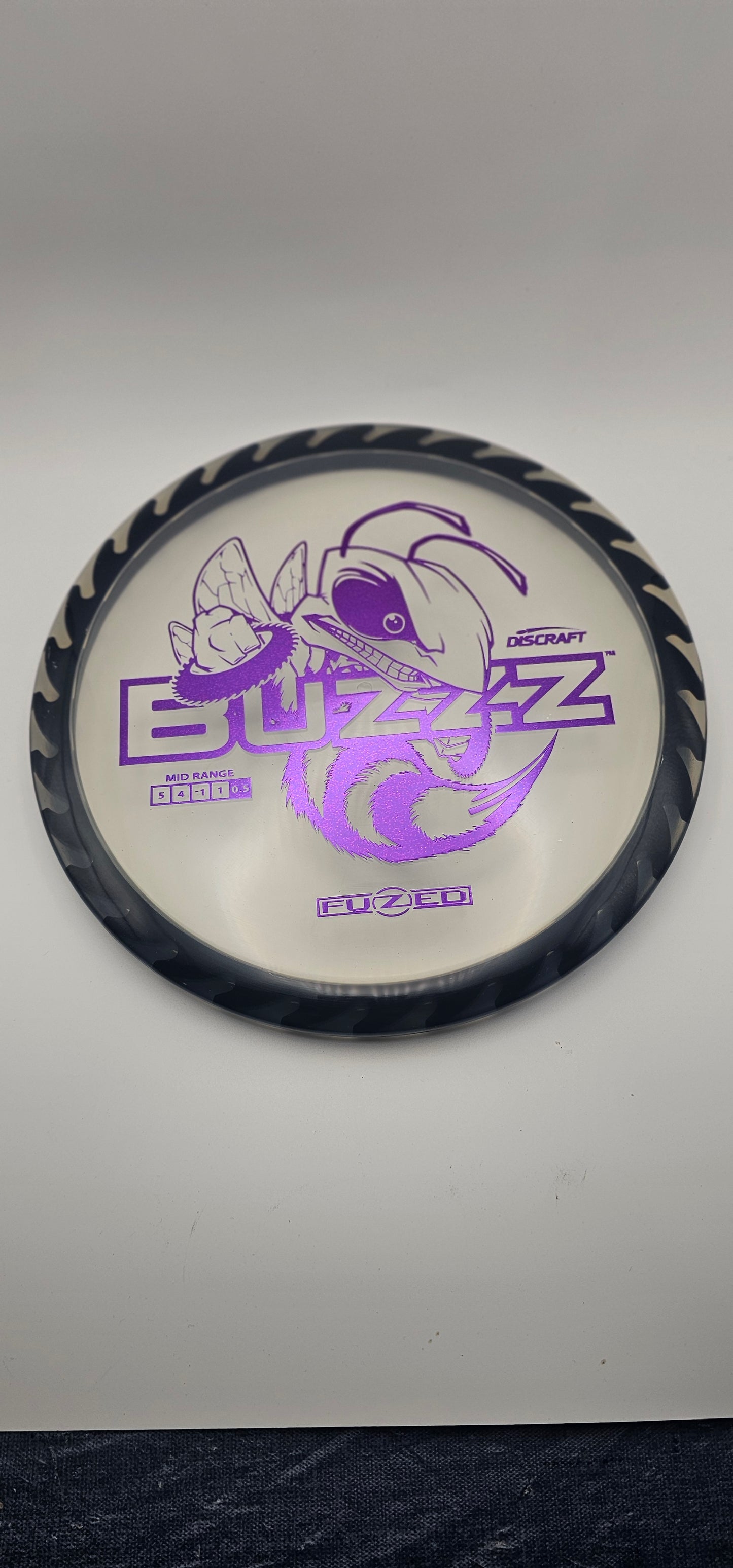 Discraft - FuZed Buzzz - Clear Plate - Black blades - Buzzzsaw - 177g+ - Purple Foil